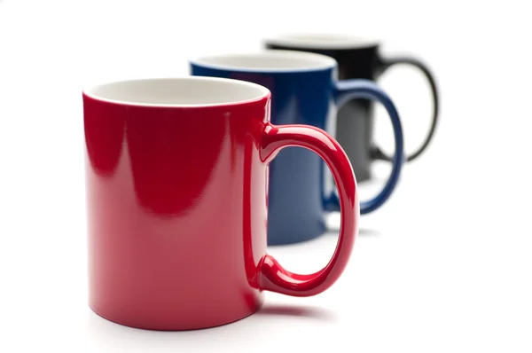 Три разноцветные чашки — стоковое фото