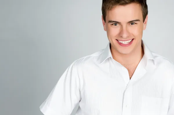 Handsome young man smiles — Stock Photo, Image