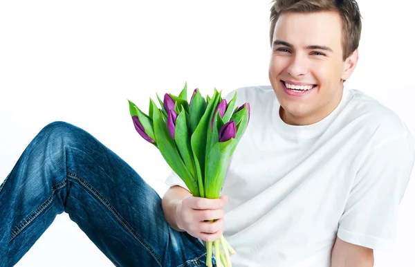 Muž s kyticí tulipánů — Stock fotografie