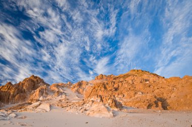 Beautiful desert landscape with stone formation and breathtaking sky in the background