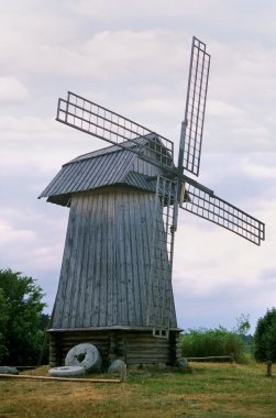 Wooden windmill in the summer clipart