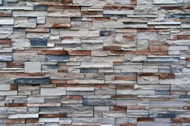 A great texture of a wall with various sized bricks. Mainly white, red, and blue. clipart