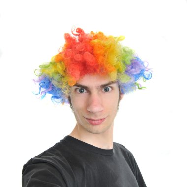 A white Caucasian young adult wearing a silly clown wig with rainbow colorful hair. clipart