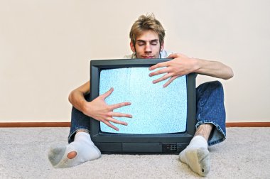 Man hugging his old CRT TV plugged into the wall with static on the screen clipart