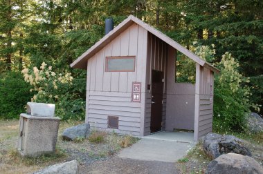 A public restroom located on a public camping site. Both men and women and handicapped. clipart