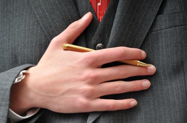 Closeup of a Businessman's gold wooden expensive pen clipart