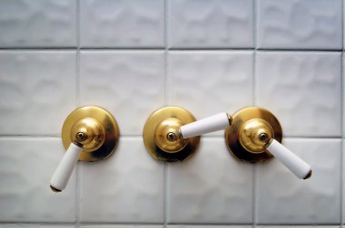 Three golden shower valve handles clipart