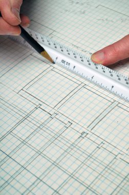 House floor plan from architecture on grid paper with ruler and hands. This makes a great background. clipart