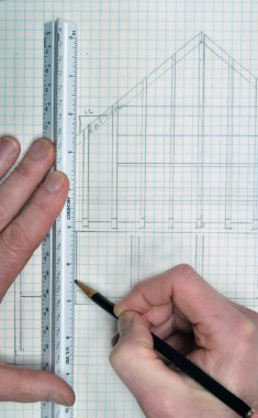 House floor plan from architect on grid paper with ruler and hands drawing the lines with a pencil. This makes a great background and has copyspace. clipart