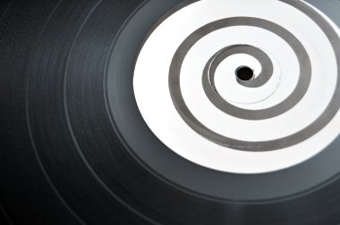 Round circular vinyl lp music record with a spiral design in the middle clipart