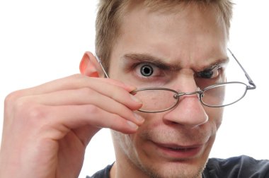 A curious white nerdy male takes down his glasses to closely inspect, examine and study his investigation. clipart
