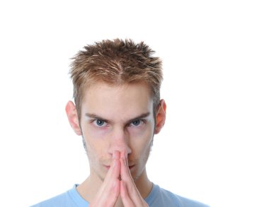 Young 18 year old man plotting his evil plan isolated on white background. clipart