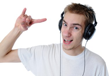 Young adult teen listens to music in his headphones. Isolated on white background. He is rocking out! clipart