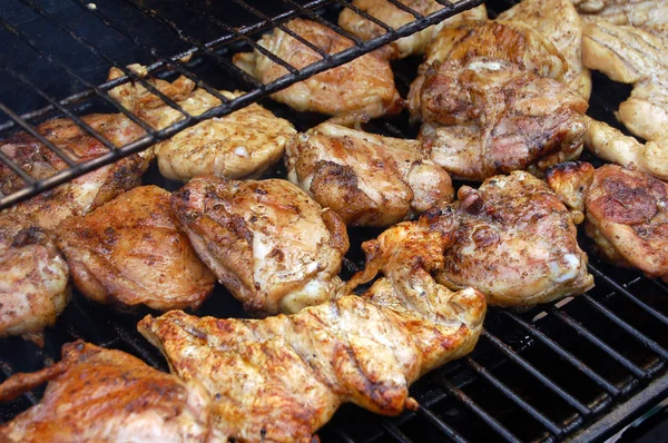 stock image Chicken meat being grilled on a barbecue.