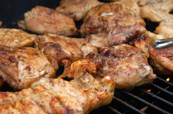 stock image Chicken roasting on grill with fire