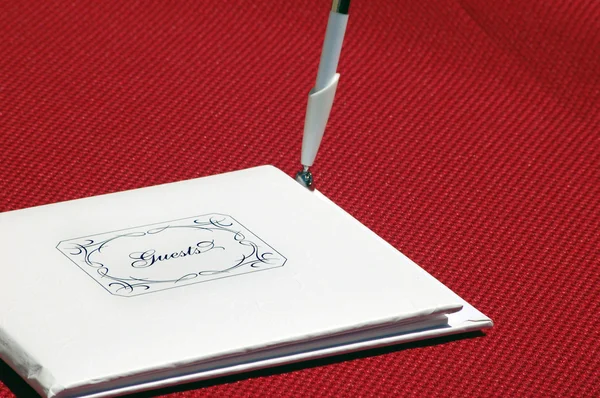 Closed White Guestbook Says Guests Front Pen Standing Side Red — Stock Photo, Image