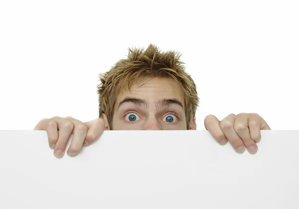 Young adult peeking above white sign — Stock Photo, Image