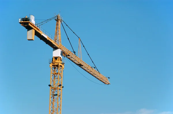 stock image A big yellow crane in the sky.