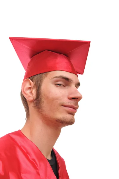Smiling graduate student in red cap and gown — Stock Photo, Image