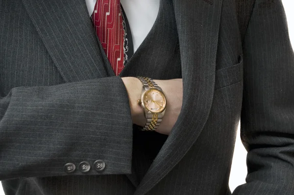 Człowiek wyższej klasy, osiągając w kieszeni z Złoty zegarek — Zdjęcie stockowe