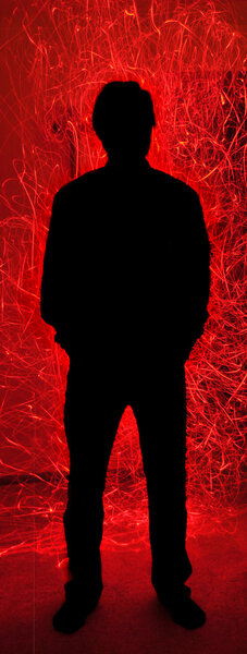 Силуэт Человек с красным огнем Искры Инферно
