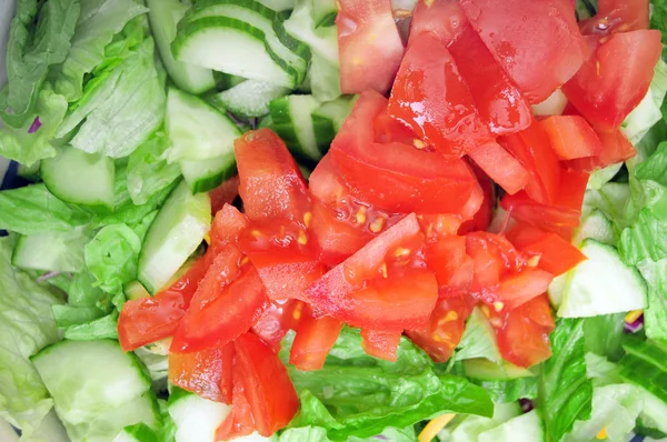 Frisch Geschnittene Tomatenwürfel Auf Grünem Salat — Stockfoto