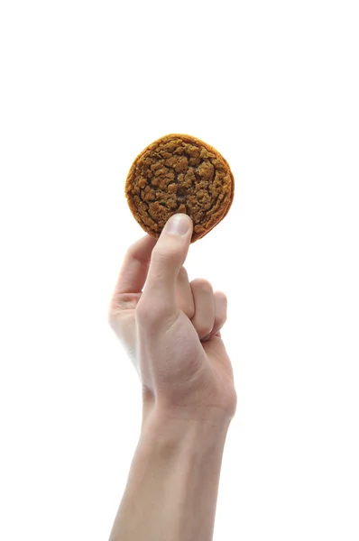 白い背景上に分離されて空中にクッキーを持っている手 — ストック写真