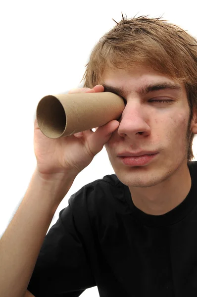 Young adult spying through tube — Stock Photo, Image