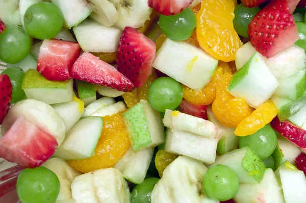 stock image A colorful variety mix of fruit salad. This includes strawberries, grapes, tangerines,pears,apples, and pears.