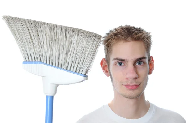 stock image Young white Caucasian male adult janitor custodian employee smiles with his broom. Isolated on white background.