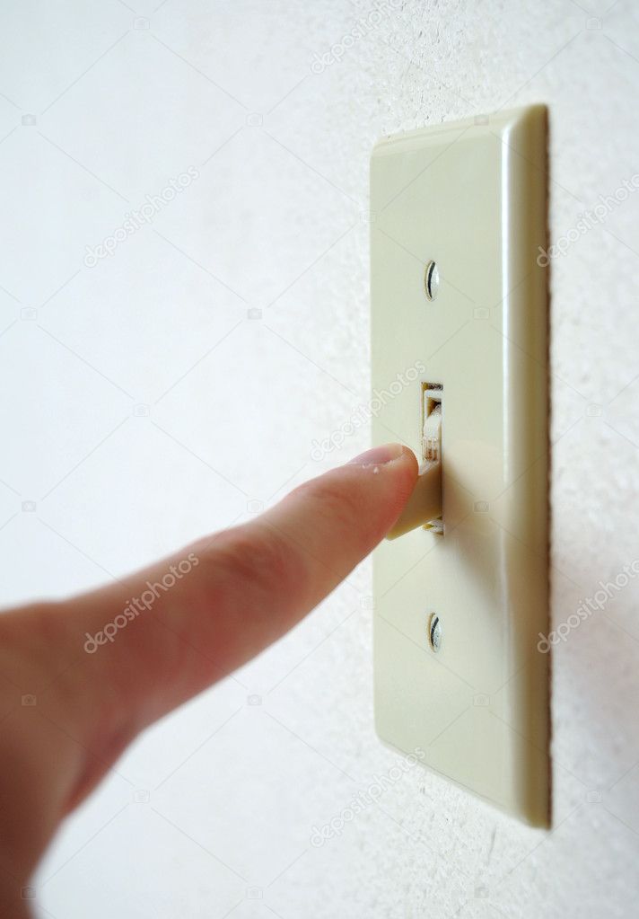 A single light switch on a white wall at an angle with a finger flipping it down, to turn it off and save power.