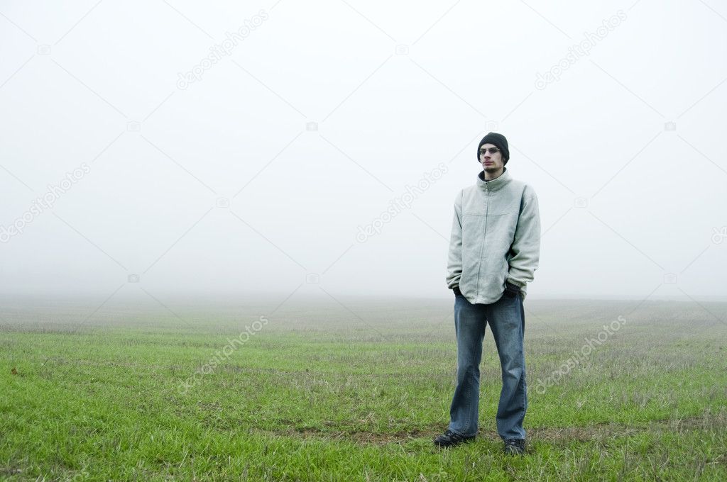 Teenager standing in field