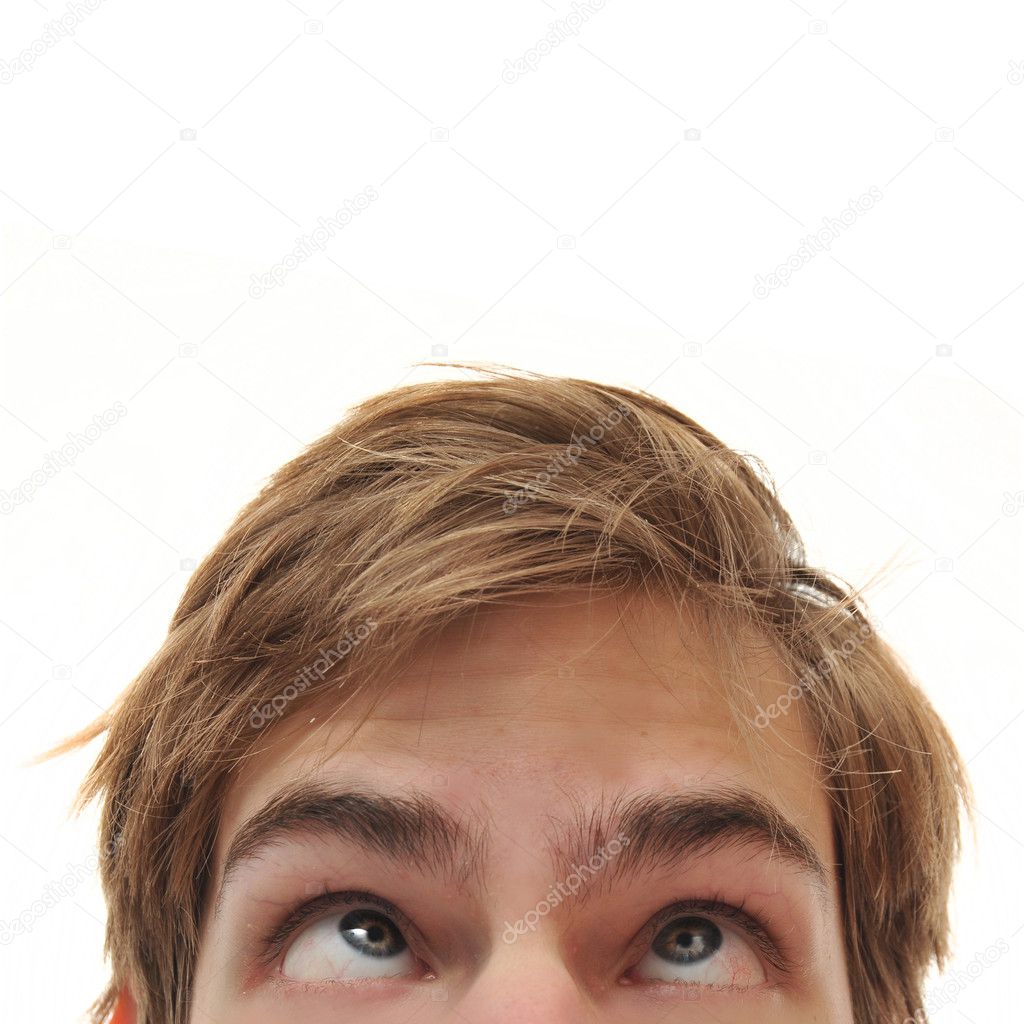 Young adult man staring up with cross eyes into empty white isolated copy space