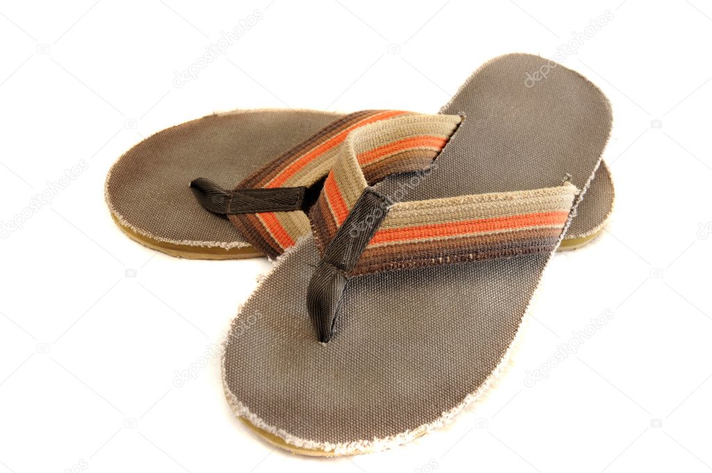Pair of brown and orange retro Jamaican junglist sandals isolated on a pure white background