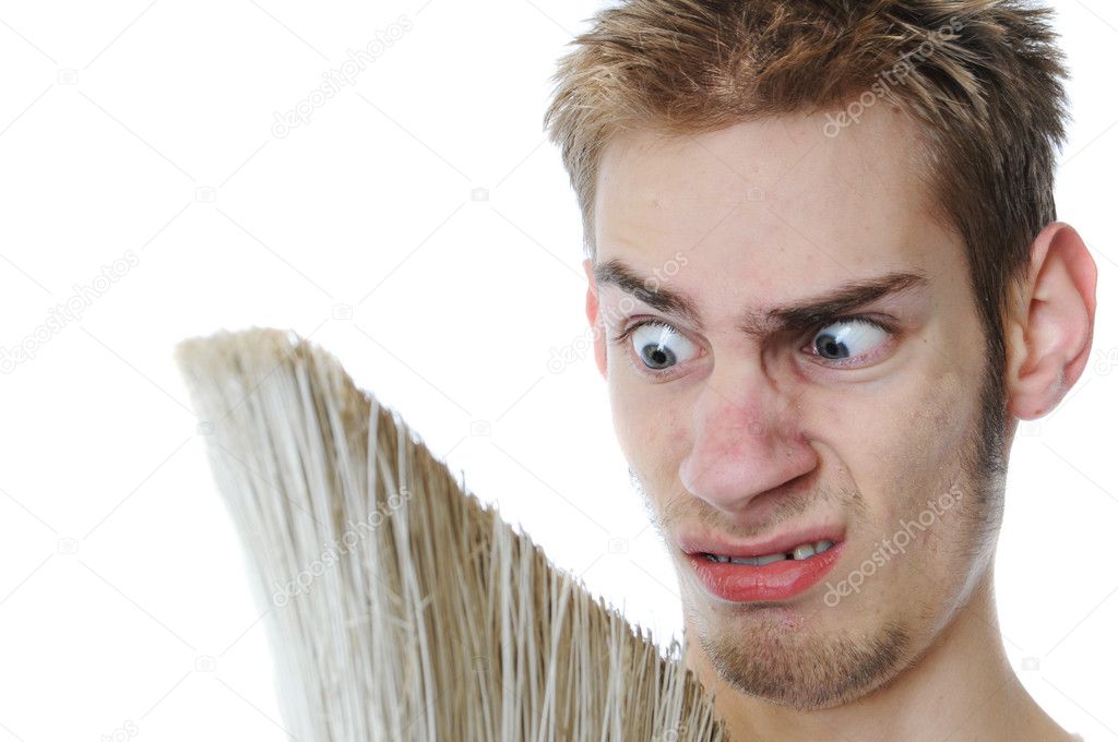 Young white Caucasian male adult janitor custodian employee with his broom. Isolated on white background.