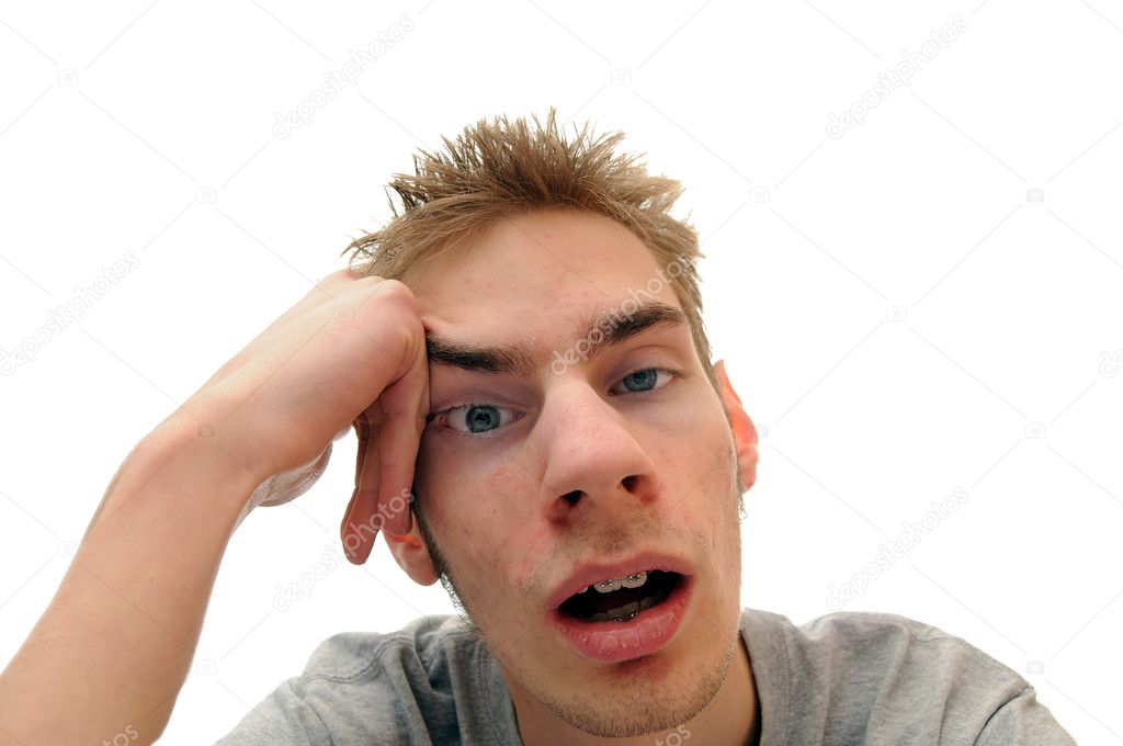 This student is bored out of his mind listening to the dull lecture that is being presented. Isolated on white background with room for your text