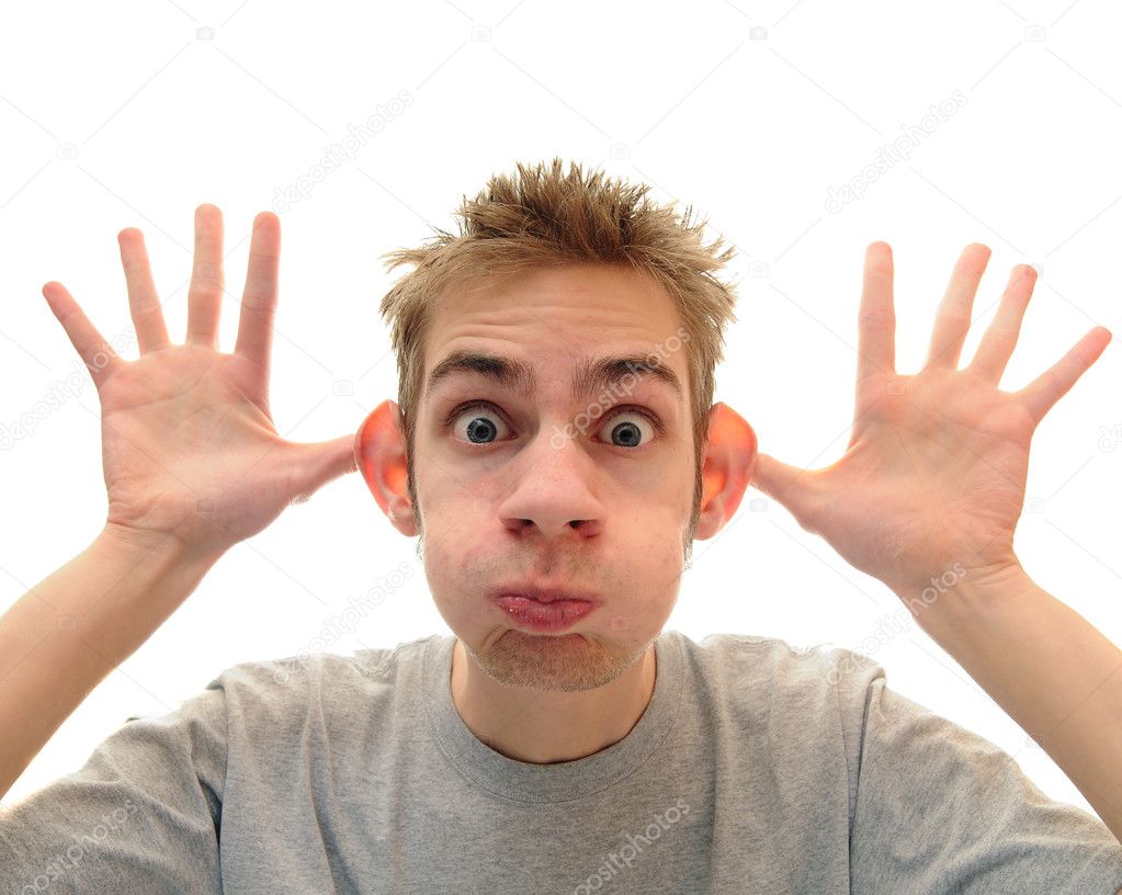 A young adult man makes a silly monkey face over a pure white background