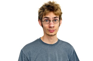 Tall skinny teenager with glasses stares at the camera with a smile in front of a pure white isolated background clipart