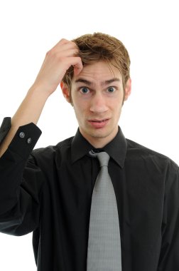 Young businessman scratches his head in confusion clipart