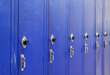 Ascending Blue High School Lockers with a spin dial for the combination code. clipart