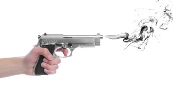 A hand gripping a pistol grip hand gun isolated on white background with black smoke with copyspace with room for your text clipart