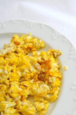 Two Scramled eggs isolated on white background on a white plate.