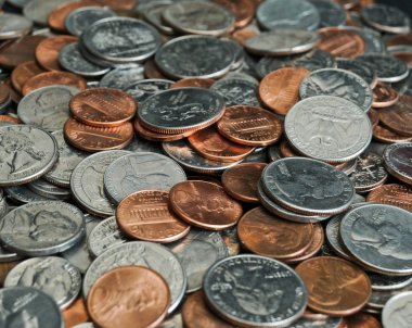 A whole bunch of American coins piled on top of one another to make this background. Shallow depth of field. clipart