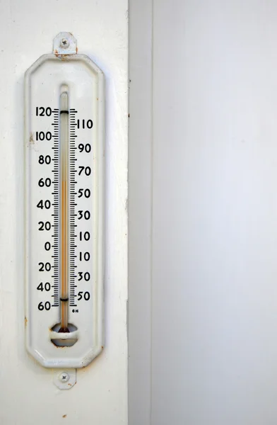 stock image White thermometer outside with the temperature at 60 degrees