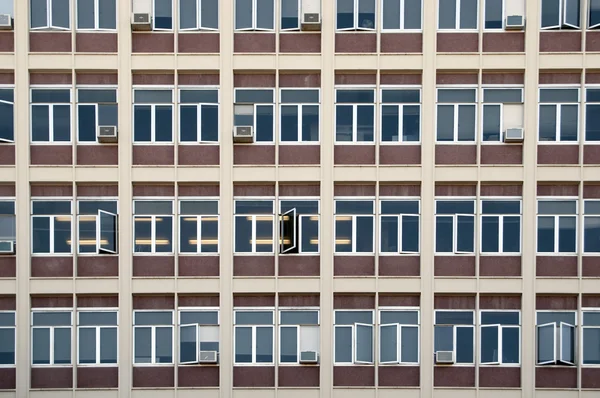 Stock image A straight flat view of an office building with windows.