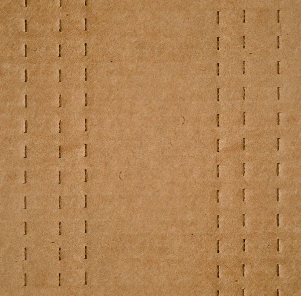 フラット折るボックスに役立つミシン目ラインと茶色の段ボール背景テクスチャ — ストック写真