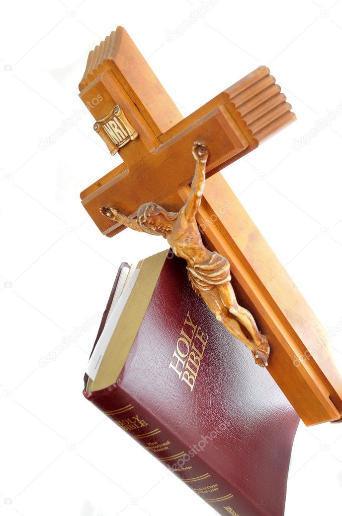 Holy Bible with a red leather cover isolated on a white background with cross