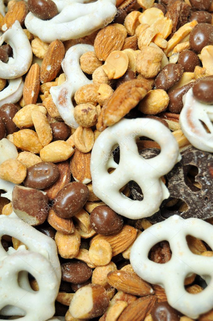 Trail mix contains white chocolate covered pretzels, chocolate covered pretzels, almonds, peanuts, pecans, walnuts, and chocolate covered raisin beans.