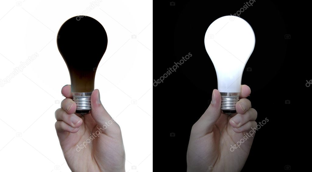 A hand holds up a black light bulb isolated on white background, and a regular white lightbulb isolated on a black background.