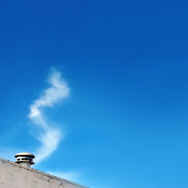 Clouds appear to be coming out of the steaming vent. In trick photography, this technique is known as 